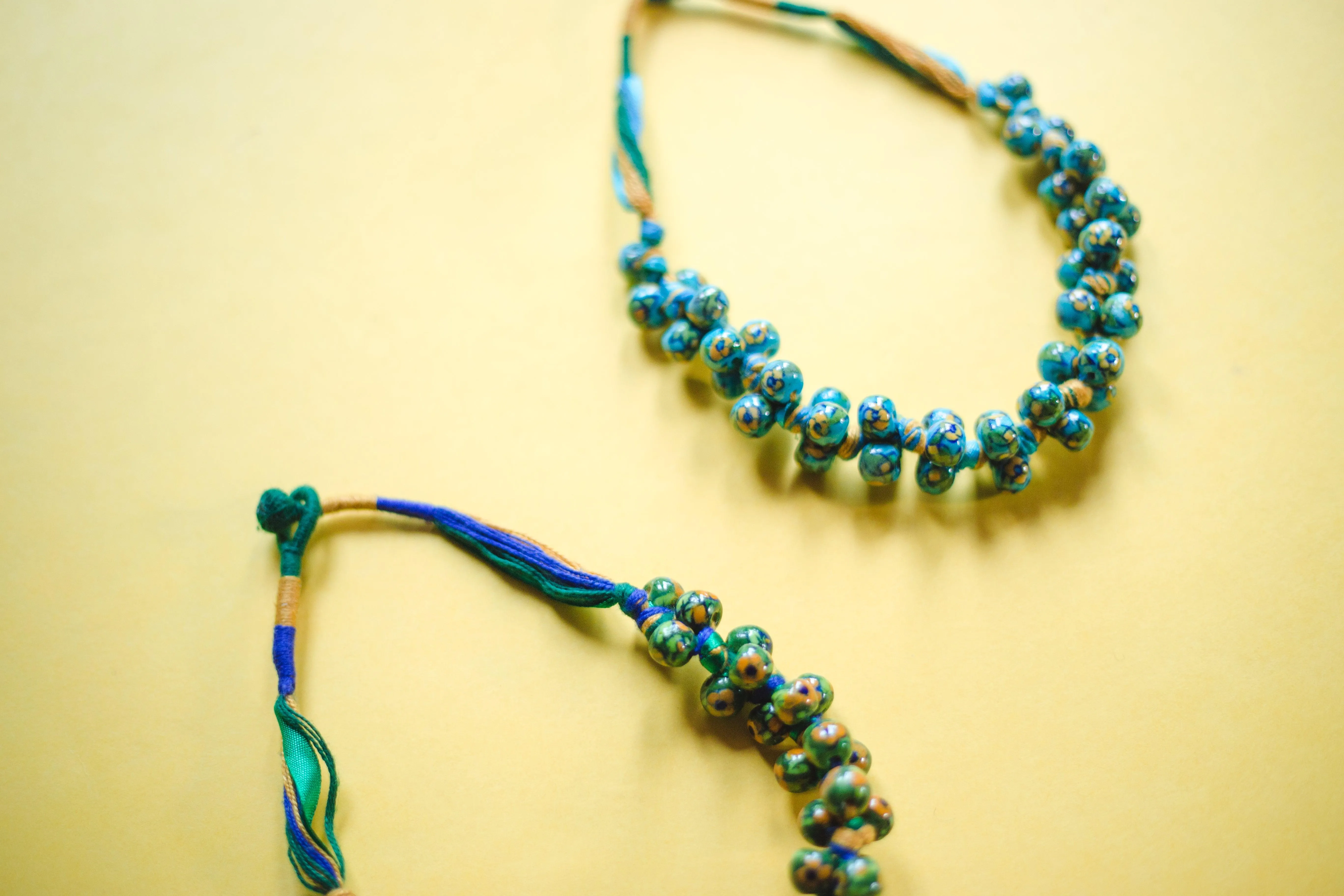 Kaisori Blue Pottery Knot necklace - green and yellow